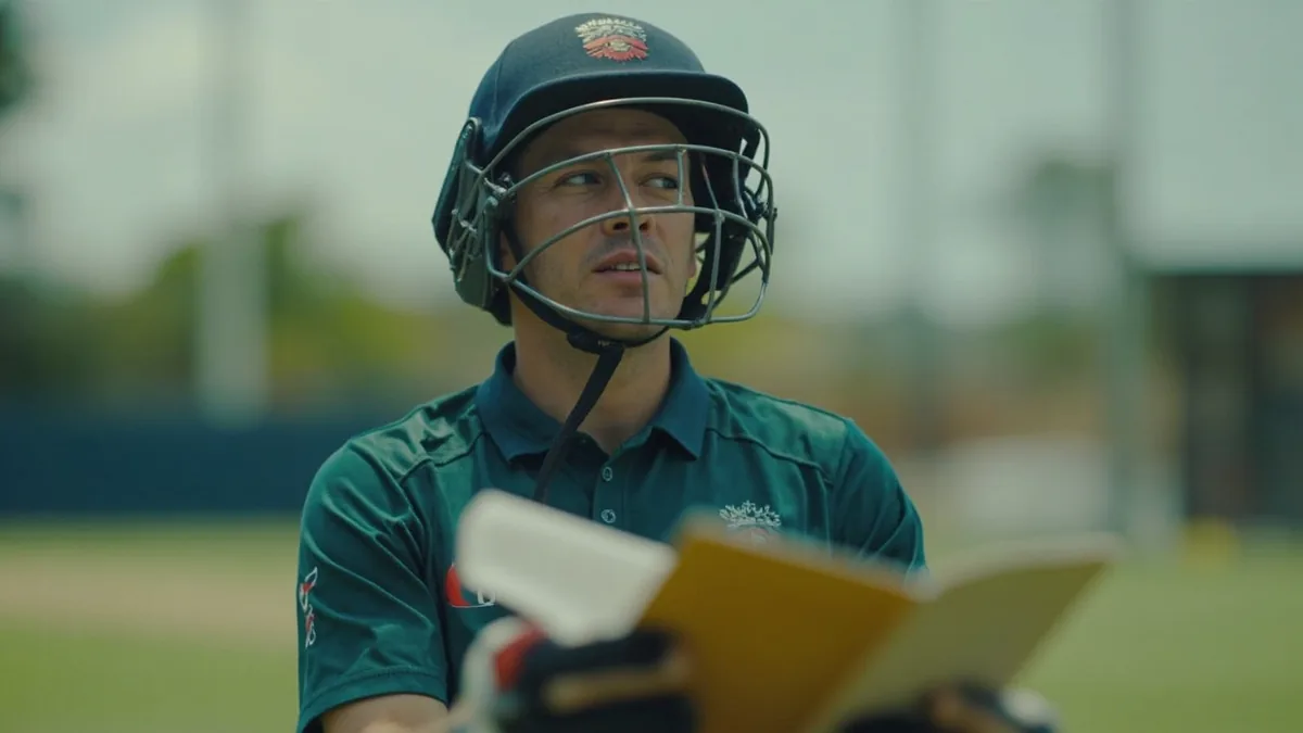 Cricket player taking break and reviewing notes during practice